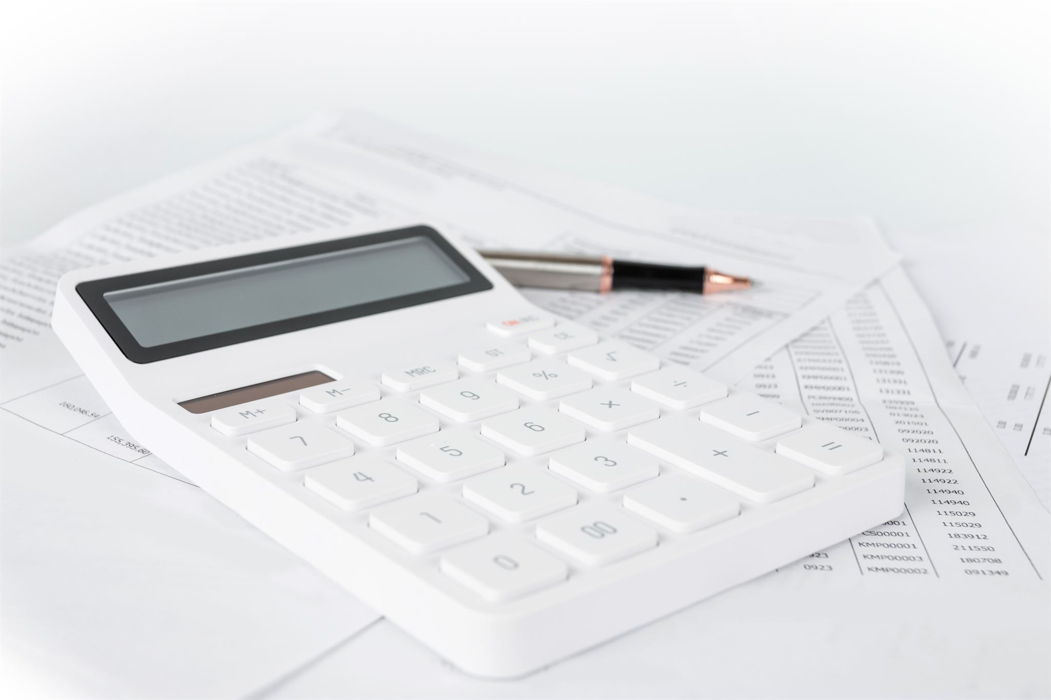 Payroll documents and calculator on desk